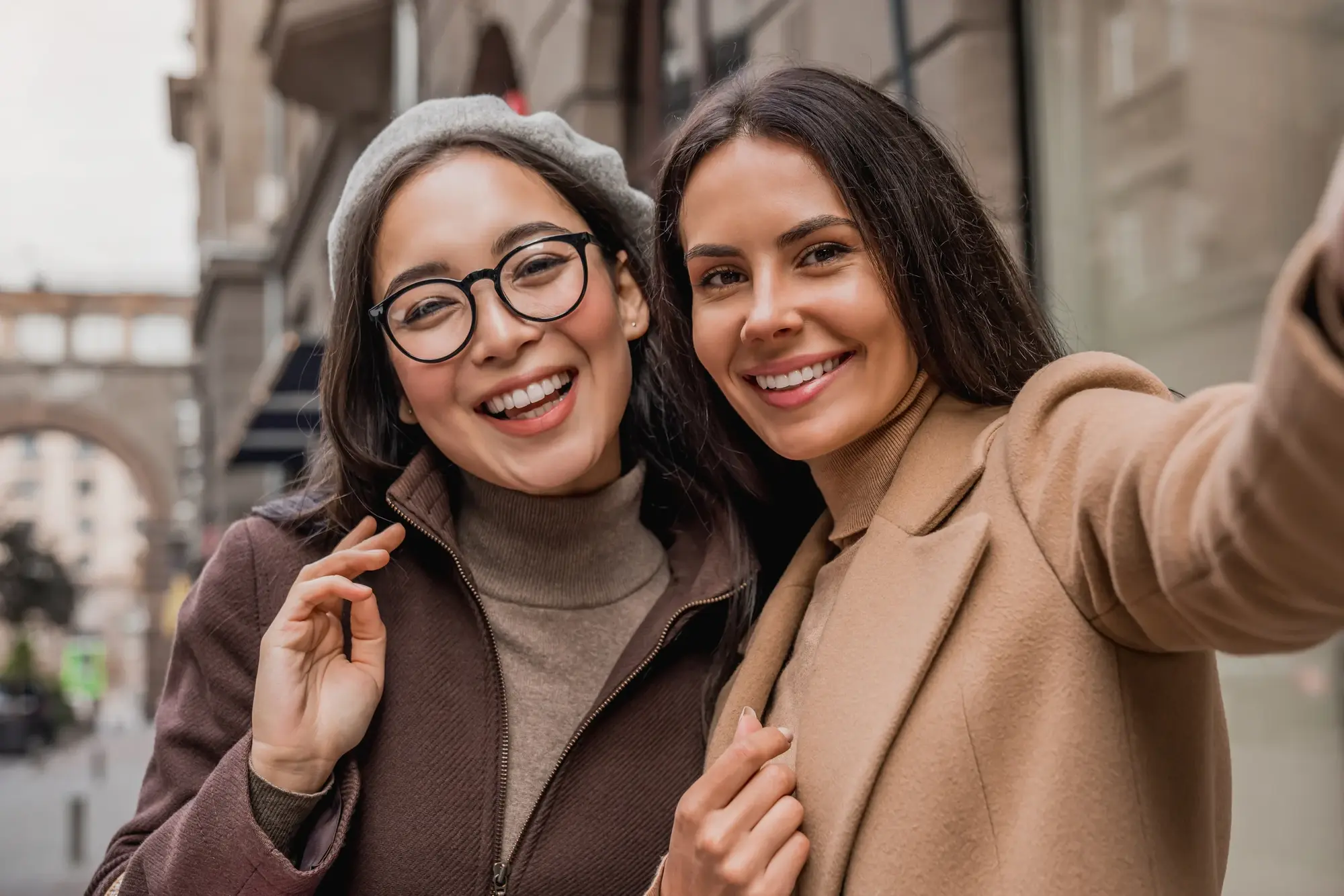 Two friends smiling together outdoors